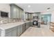 Charming kitchen featuring stainless steel appliances, mosaic tile backsplash, and ample gray cabinetry at 7586 Sea Mist Dr, Port Charlotte, FL 33981