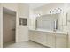 Bathroom featuring double sink vanity, a large mirror and a walk-in shower at 109 Westwind Dr, Placida, FL 33946