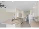 Bright kitchen showcasing white appliances, tiled floors, and plenty of counter space at 109 Westwind Dr, Placida, FL 33946
