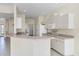 Open kitchen with white cabinets and breakfast bar, offering ample counter space at 109 Westwind Dr, Placida, FL 33946