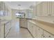 Sunlit kitchen with long counters and white cabinets at 109 Westwind Dr, Placida, FL 33946