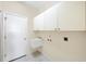 Practical laundry room with sink and storage space at 109 Westwind Dr, Placida, FL 33946