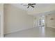 Bright living room featuring tile floors, a ceiling fan, and a clear view through the front doors at 109 Westwind Dr, Placida, FL 33946