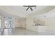 Spacious open living area with tile floors, stylish lighting, and partial kitchen view at 109 Westwind Dr, Placida, FL 33946