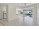 Open-concept living area with tile flooring and sliding glass doors to the pool area at 109 Westwind Dr, Placida, FL 33946