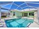 Inviting screened pool surrounded by lush landscaping, perfect for relaxation at 109 Westwind Dr, Placida, FL 33946
