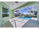 Inviting screened pool with a view of lake and golf course at 109 Westwind Dr, Placida, FL 33946