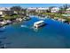 Picturesque aerial view of a boat navigating through clear, blue waters surrounded by waterfront homes at 11000 Placida Rd # 301, Placida, FL 33946