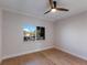 Bedroom featuring hardwood floors, a ceiling fan, and large windows at 11000 Placida Rd # 301, Placida, FL 33946
