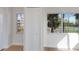 Bright room with hardwood floors and view of a tennis court through two windows at 11000 Placida Rd # 301, Placida, FL 33946