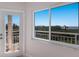 Bedroom features a large window and a balcony with a scenic waterfront view at 11000 Placida Rd # 301, Placida, FL 33946