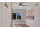 Condo entryway with a view of a white kitchen featuring stainless steel appliances, white cabinets, and quartz countertops at 11000 Placida Rd # 301, Placida, FL 33946