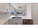 Bright, modern kitchen featuring white cabinets, stainless steel appliances, quartz countertops and beautiful water views at 11000 Placida Rd # 301, Placida, FL 33946