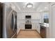 Bright kitchen with stainless steel appliances, white cabinetry, quartz countertops, and hardwood floors at 11000 Placida Rd # 301, Placida, FL 33946