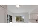 Bright living room with hardwood floors and a large window with view of palm trees and a tennis court at 11000 Placida Rd # 301, Placida, FL 33946