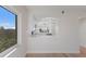 Bright, open concept living room with hardwood floors and view of a modern white kitchen at 11000 Placida Rd # 301, Placida, FL 33946