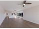 Bright living room with hardwood floors, ceiling fans, and view to kitchen at 11000 Placida Rd # 301, Placida, FL 33946