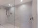 Bathroom shower featuring white marble-style tiles and modern fixtures at 11000 Placida Rd # 301, Placida, FL 33946