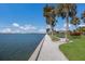 Scenic waterfront walkway lined with palm trees, offering picturesque views of the bay and a tranquil atmosphere at 11000 Placida Rd # 301, Placida, FL 33946