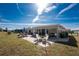 A view of the backyard of the home shows the patio with an outdoor table and fire pit at 13532 Romford Ave, Port Charlotte, FL 33981
