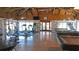 Spacious clubhouse interior with exercise equipment, pool table, ping pong, and stone details at 13532 Romford Ave, Port Charlotte, FL 33981