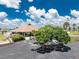 Beautifully landscaped clubhouse with ample parking and manicured grounds under a sunny sky at 13532 Romford Ave, Port Charlotte, FL 33981