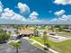 Community clubhouse featuring a swimming pool, tennis courts, and well-maintained landscaping at 13532 Romford Ave, Port Charlotte, FL 33981