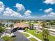 Community clubhouse featuring a swimming pool, tennis courts, and well-manicured landscaping at 13532 Romford Ave, Port Charlotte, FL 33981