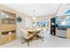 Cozy dining area adjacent to the kitchen, featuring tile floors and views to the backyard at 13532 Romford Ave, Port Charlotte, FL 33981