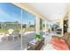 Light-filled sunroom showcasing tiled floors and a view of the outdoor seating area at 13532 Romford Ave, Port Charlotte, FL 33981