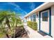 Inviting front entrance with well-maintained landscaping leading to the front door with sidelight windows at 13532 Romford Ave, Port Charlotte, FL 33981