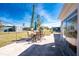 A backyard patio with an outdoor table provides a place to gather for al fresco dining and relaxation at 13532 Romford Ave, Port Charlotte, FL 33981