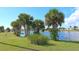 Beautiful pond surrounded by lush greenery and palm trees at 13532 Romford Ave, Port Charlotte, FL 33981