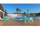 Inviting community pool with seating areas and serene lake views at 13532 Romford Ave, Port Charlotte, FL 33981