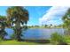 Scenic water view with lush tropical palm trees, blue skies and tranquil waters in a serene setting at 13532 Romford Ave, Port Charlotte, FL 33981