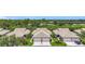 Aerial view of villas, well-maintained landscaping, and a serene neighborhood setting at 1577 Monarch Dr # 1577, Venice, FL 34293