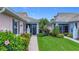 Inviting home with a walkway through lush landscaping and screened-in front porch at 1577 Monarch Dr # 1577, Venice, FL 34293