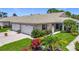 Charming villa with a well-manicured lawn, colorful flowerbeds, and a two-car garage at 1577 Monarch Dr # 1577, Venice, FL 34293