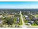 Aerial view of a suburban neighborhood featuring well-kept homes, tree-lined streets, and lush landscaping. Captures a peaceful community at 252 Australian Dr, Rotonda West, FL 33947