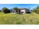 Backyard featuring a screened-in lanai and a well-maintained lawn at 252 Australian Dr, Rotonda West, FL 33947