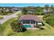 Aerial view of a backyard featuring a screened-in pool and lush landscaping at 252 Australian Dr, Rotonda West, FL 33947