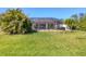 Lush backyard offering a screened-in lanai with ample space at 252 Australian Dr, Rotonda West, FL 33947