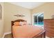 Comfortable bedroom offers a serene view of the pool area through sliding glass doors at 252 Australian Dr, Rotonda West, FL 33947
