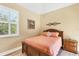 Sunlit bedroom featuring a shuttered window and ample natural light at 252 Australian Dr, Rotonda West, FL 33947