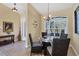 Cozy dining area with a round glass table, comfortable chairs, and natural light, perfect for Gathering meals at 252 Australian Dr, Rotonda West, FL 33947