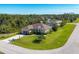 Landscaped exterior showcasing a well-maintained lawn, mature trees, and a private driveway at 252 Australian Dr, Rotonda West, FL 33947