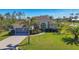 Charming home with a well-manicured lawn, lush landscaping, and a spacious two-car garage at 252 Australian Dr, Rotonda West, FL 33947
