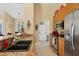 Well-equipped kitchen featuring granite counters, stainless appliances, and ample cabinet space with laundry room access at 252 Australian Dr, Rotonda West, FL 33947