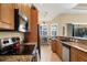 Modern kitchen featuring stainless steel appliances and granite countertops with a view into the dining area and living room at 252 Australian Dr, Rotonda West, FL 33947