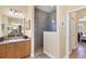 Main bathroom features a large vanity, glass enclosed shower, and neutral color palette at 252 Australian Dr, Rotonda West, FL 33947